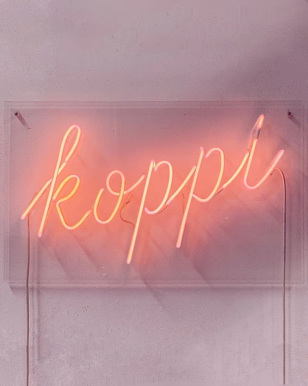 The koppi neon sign on the wall at the roastery in Helsingborg