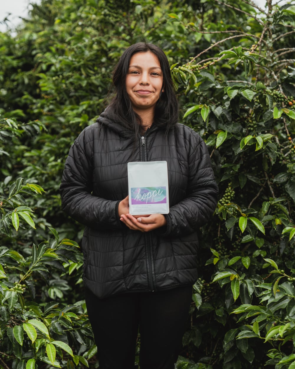 Karen Burbano holding a bag of Koppi coffee at Finca El Placer, San Agustín